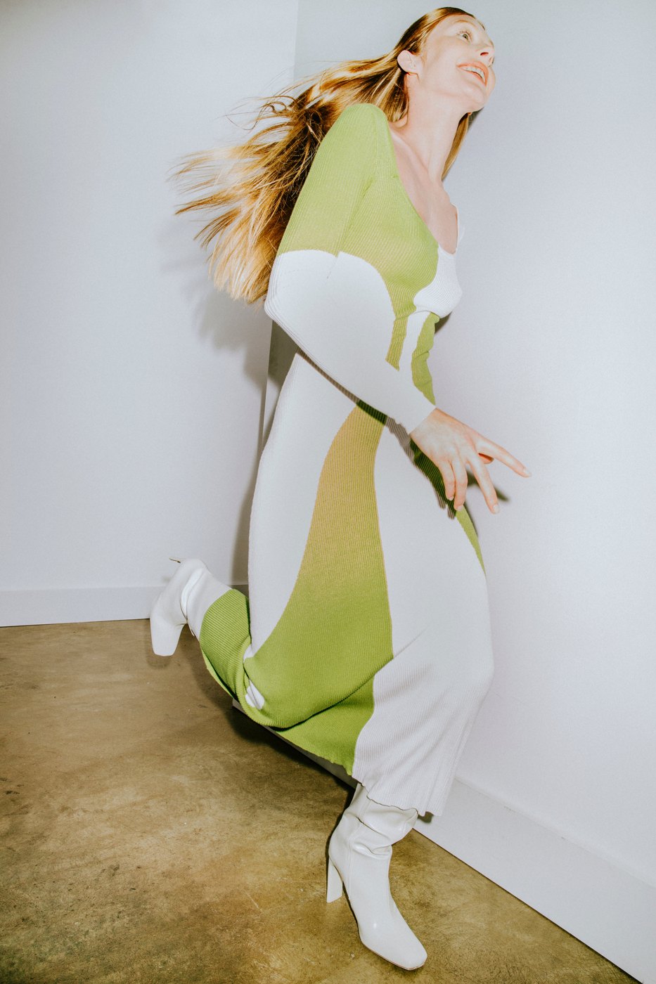 Model running in a white and lime dress