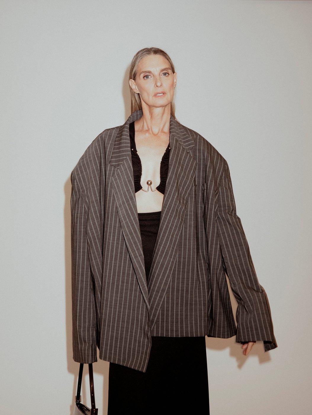 Model in an oversized pinstriped blazer