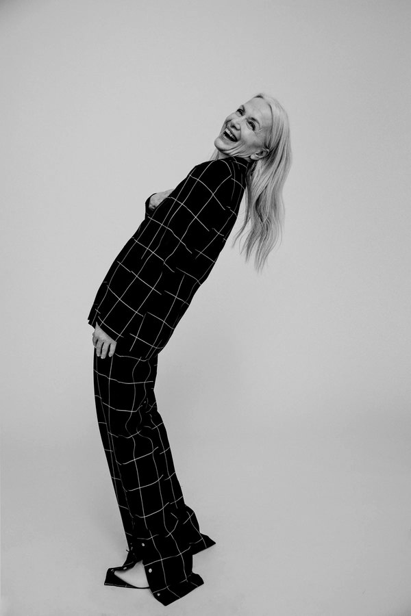 Woman in plaid pyjamas leaning backward