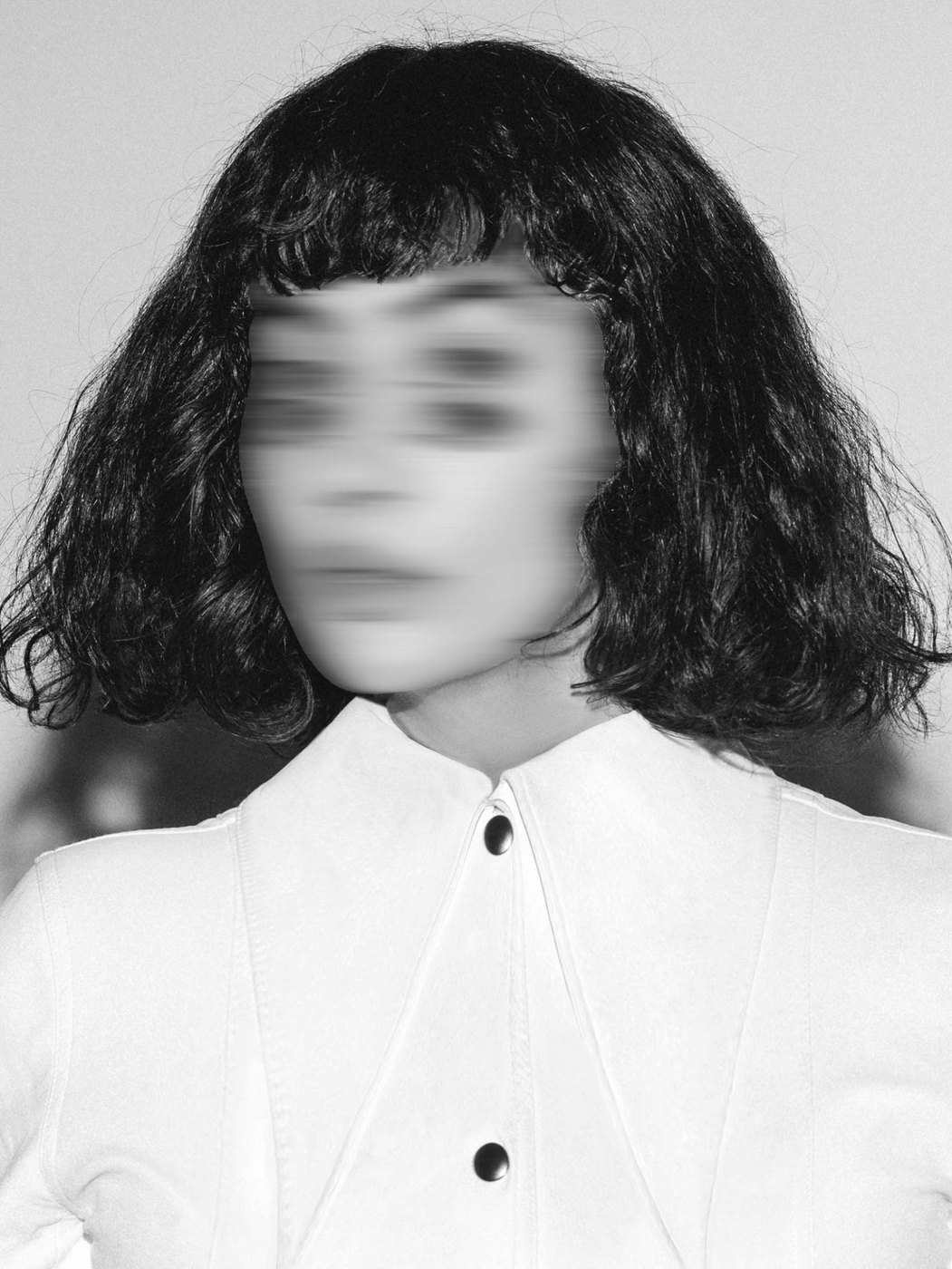 Blurred black and white portrait of a woman in a white shirt