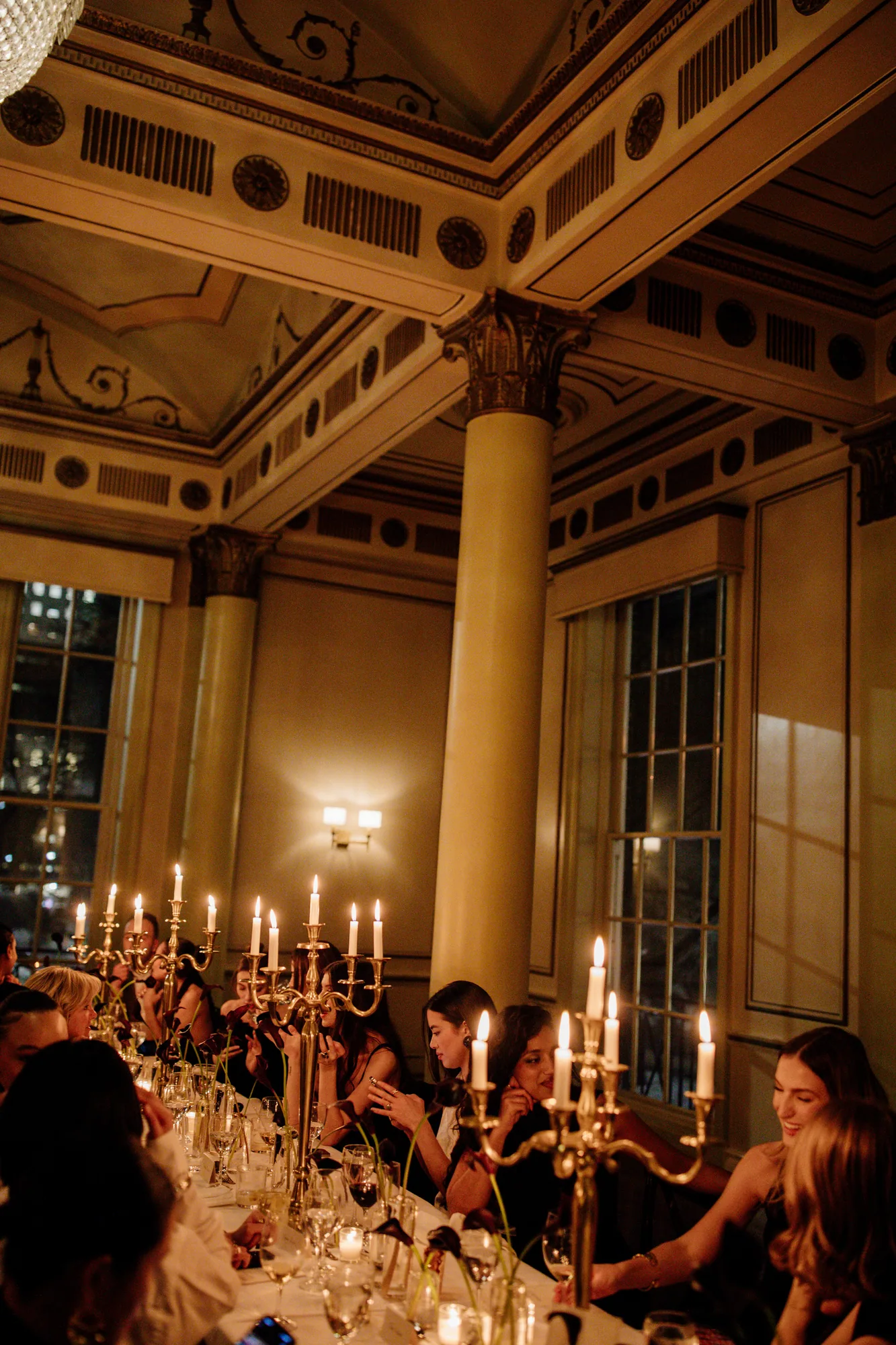 Candlelit banquet in a grand columned hall