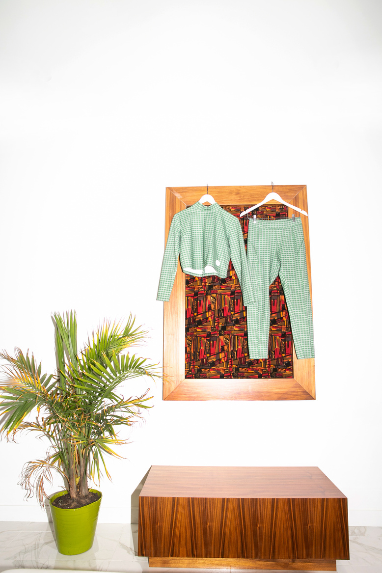 Green checked outfit displayed in a bright modern interior