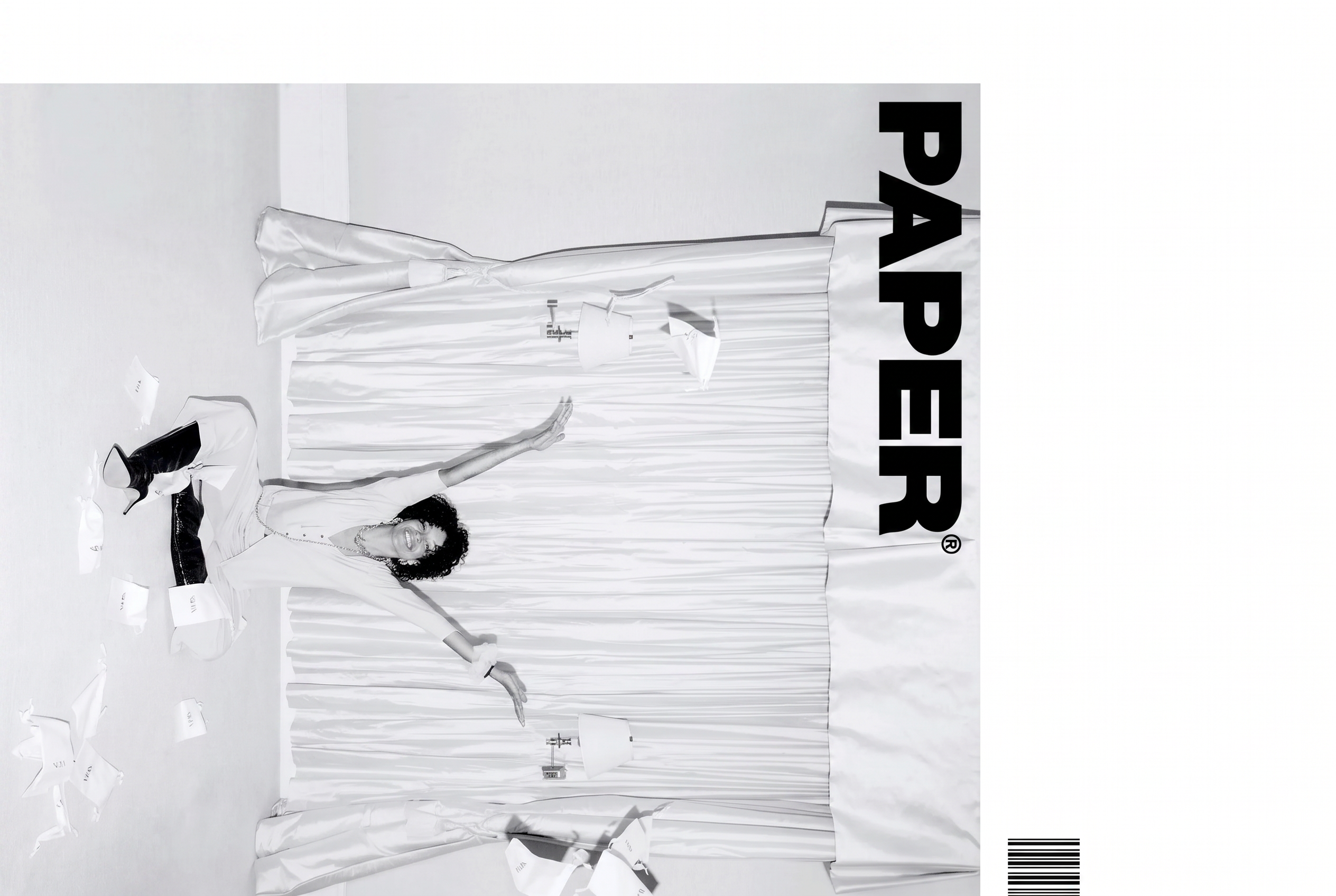 PAPER magazine cover in black and white, model in white against a curtain