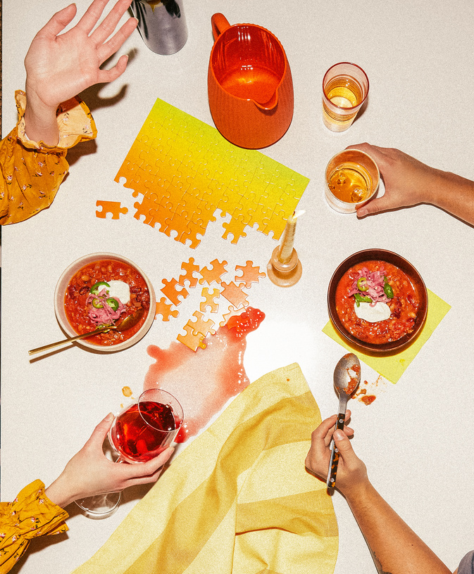 Overhead table with soup and a bright yellow puzzle