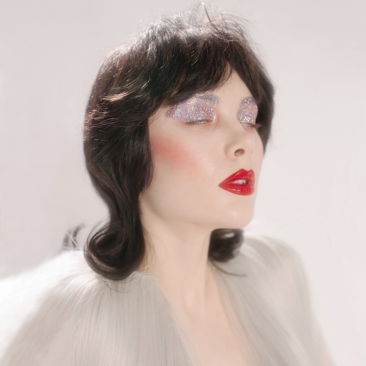 Beauty portrait with glitter eyeshadow and red lipstick